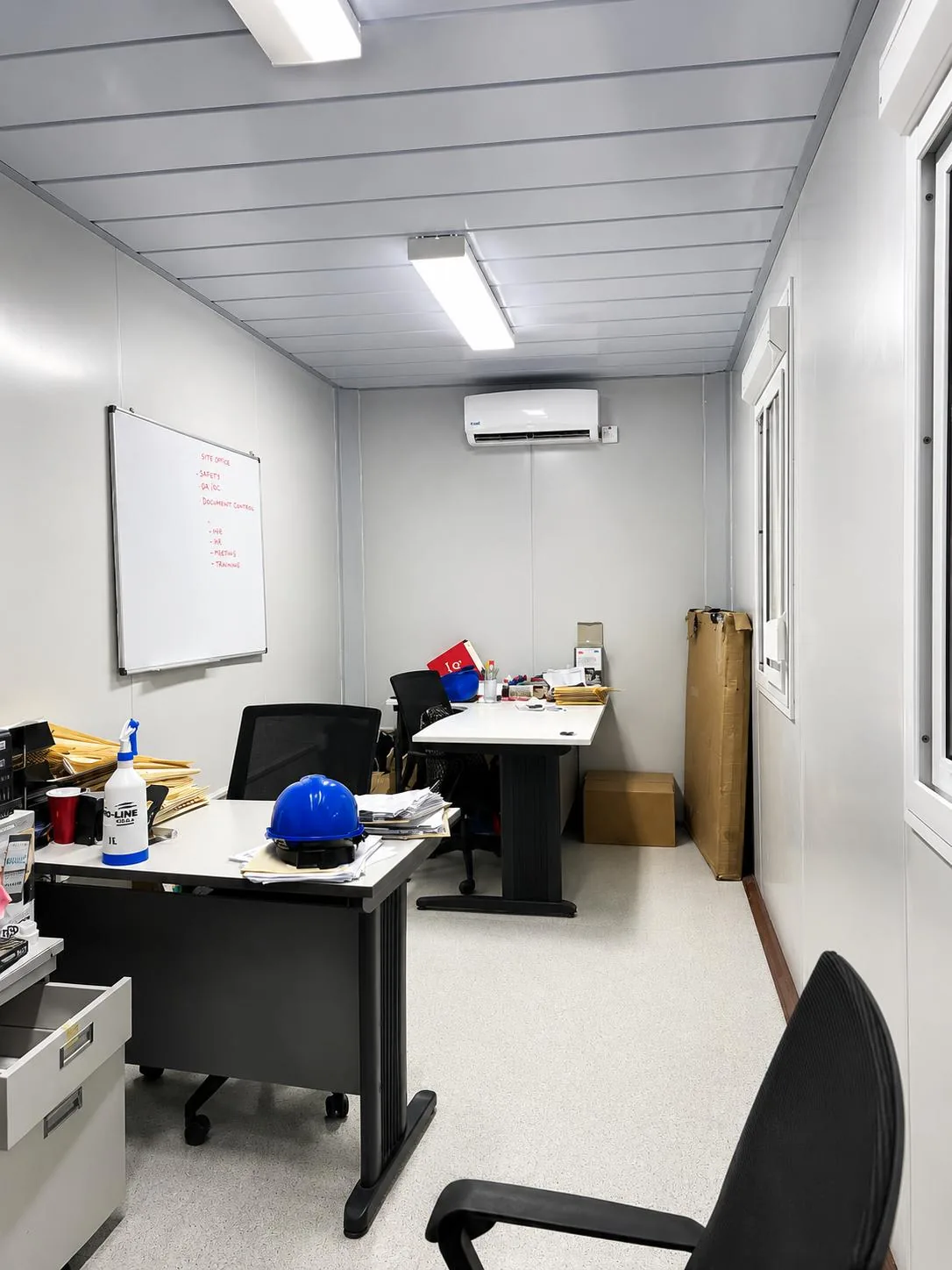 Container office with modern workstations and whiteboards